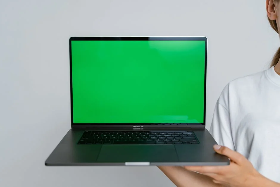 A modern computer screen displaying web design work, showcasing creative visuals in a workspace.